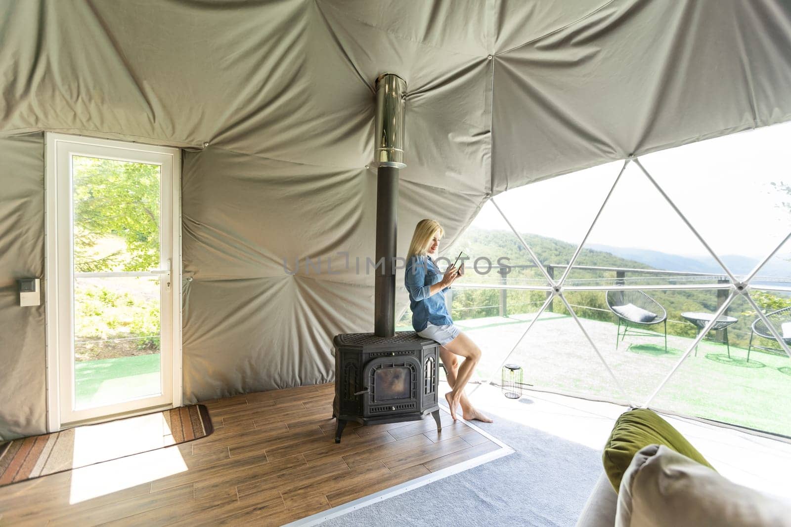 woman with tablet in dome tent.