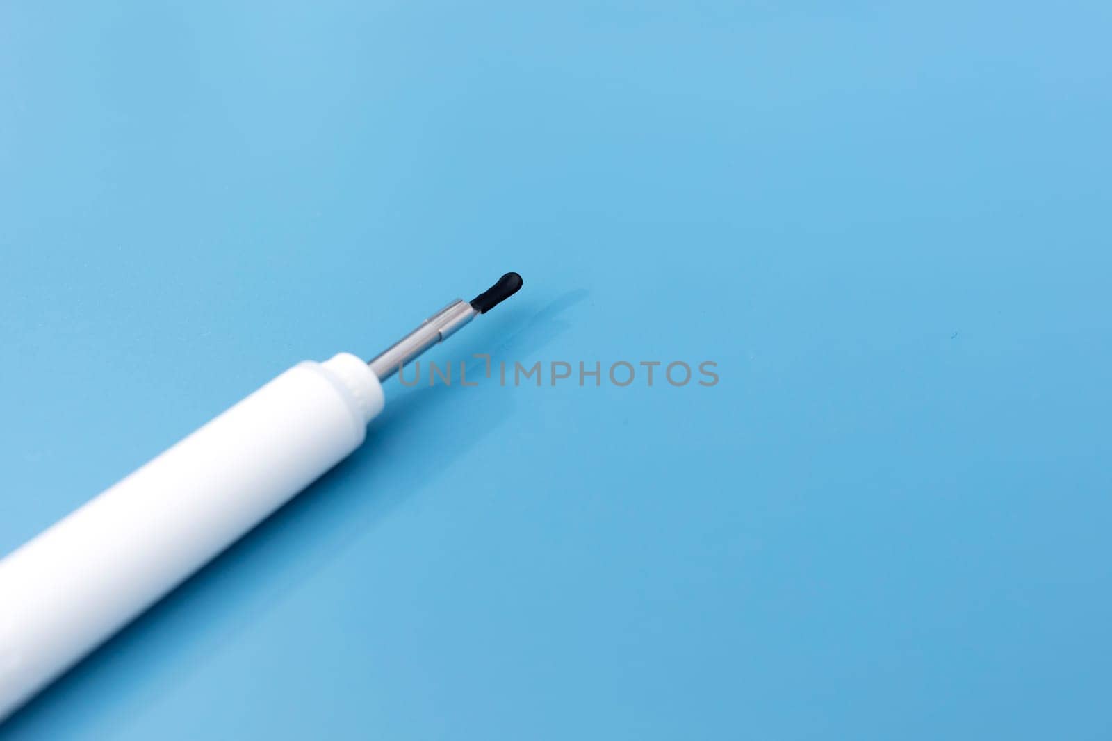 Template Ear Scope For Wax Removal Tool on Blue Background. Digital Otoscope, Earwax Cleaner With Gyroscope, Camera, Light. Copy Space. Cleaning Ears Device Connected to Smartphone Technology.