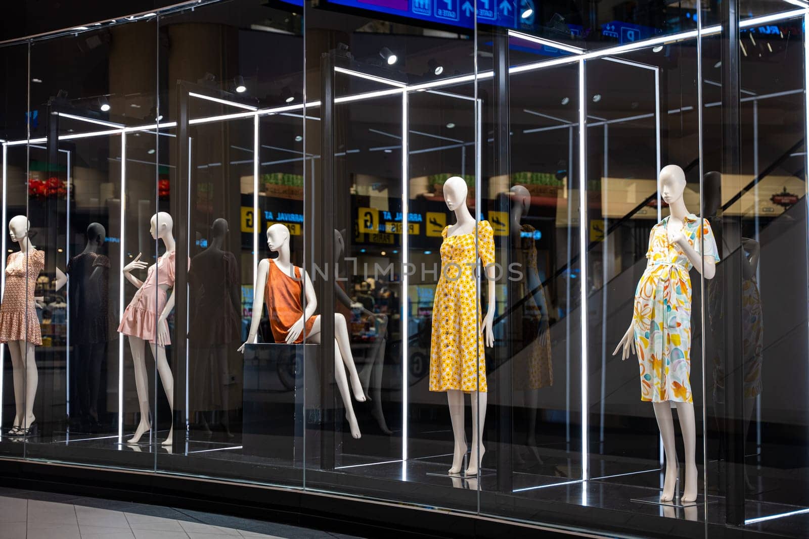 Colorful and artistic mannequins in a store display case by Sorapop