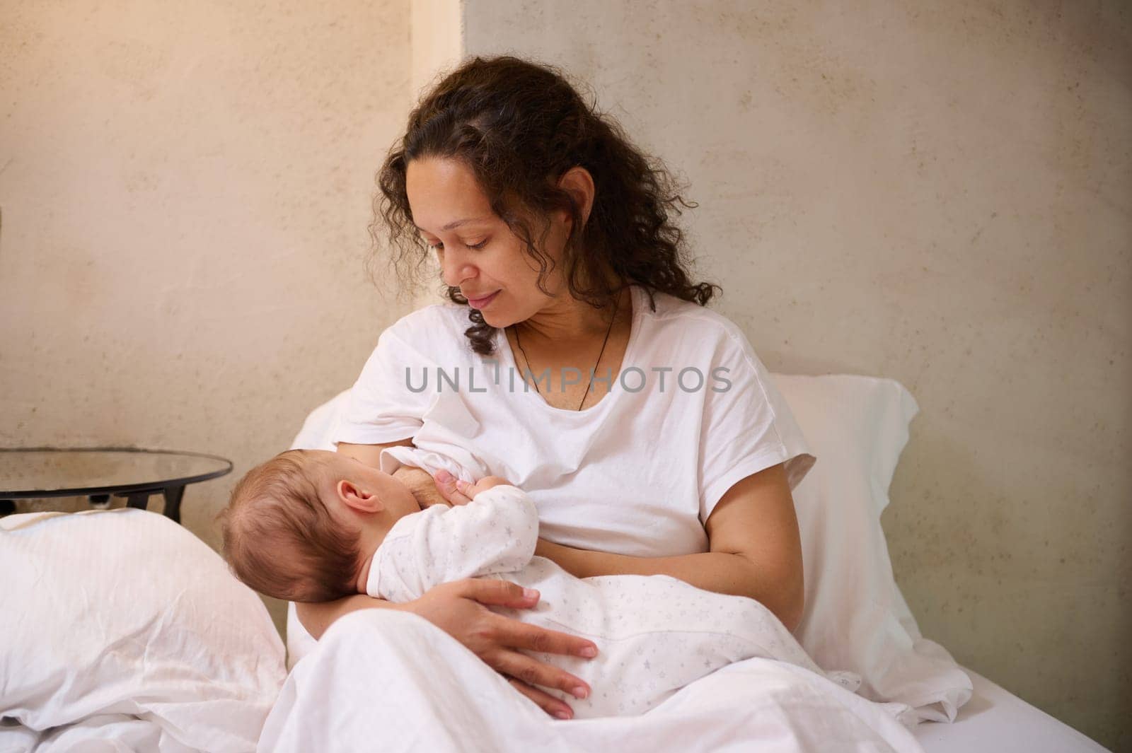 Newborn baby boy sucking milk from mothers breast. Infancy, pregnancy and maternity leave lifestyle by artgf
