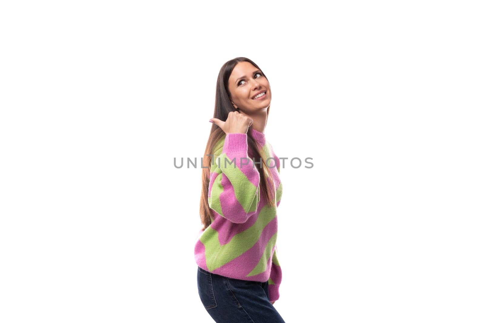 young happy caucasian woman with straight black hair is dressed in a stylish striped pink pullover by TRMK