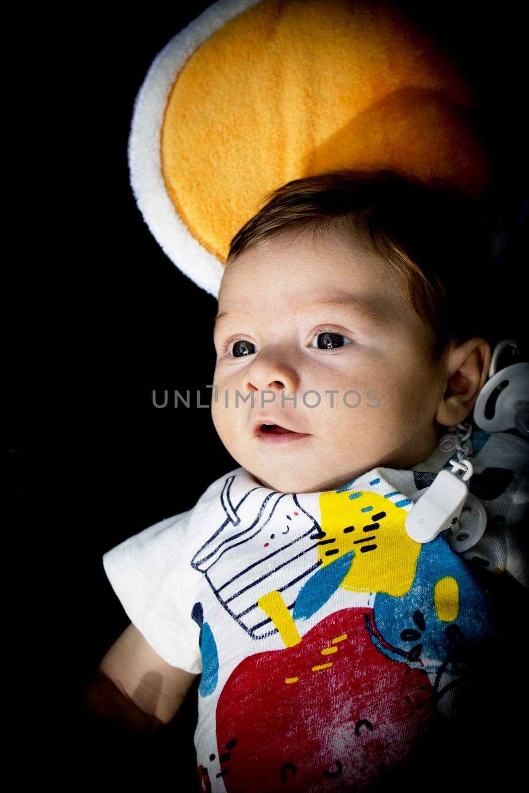 Two month old baby lying on a towel by GemaIbarra