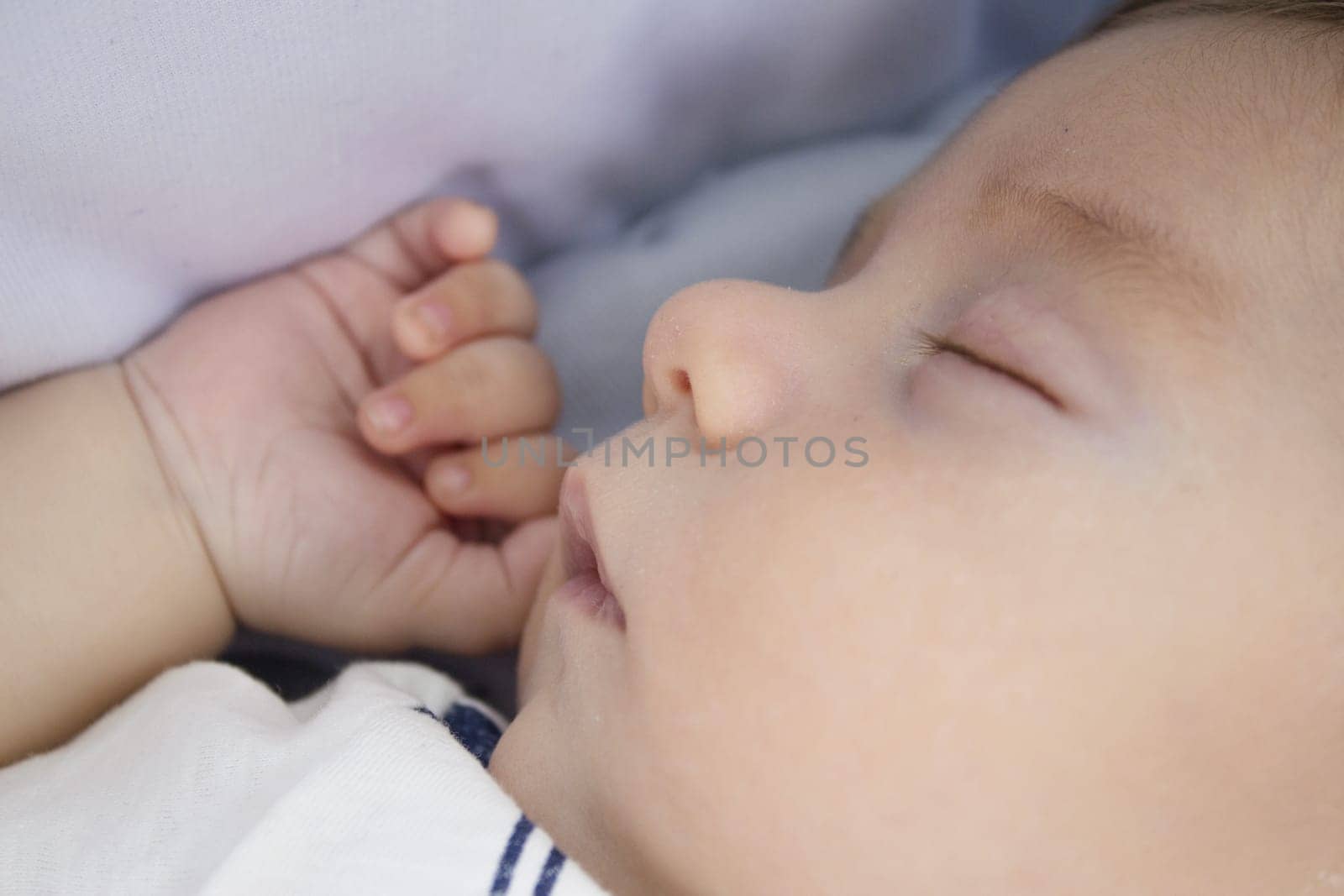 Two month old baby sleeping with hand next to face. Relax scene