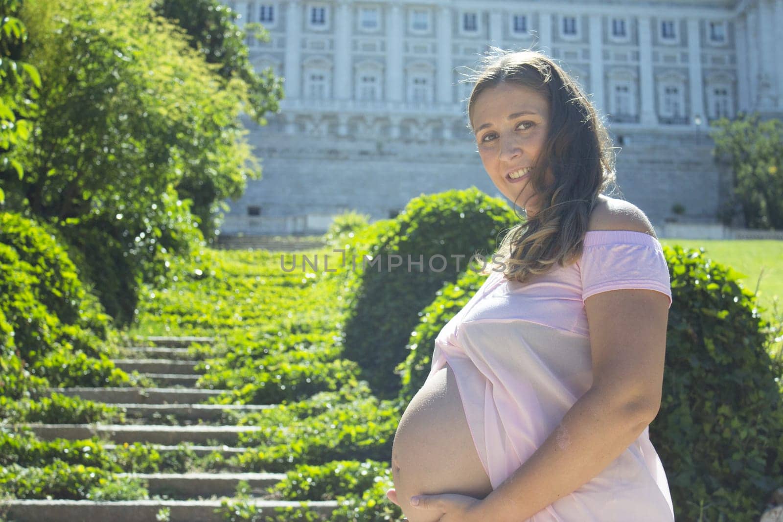 Pregnant woman with pink dress in a park by GemaIbarra