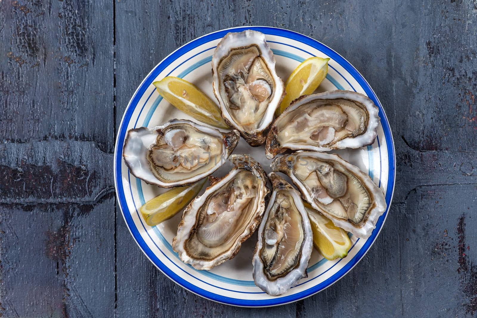 plate of oysters fresh seafood healthy meal on the table copy space food background rustic top view pescatarian diet by JPC-PROD