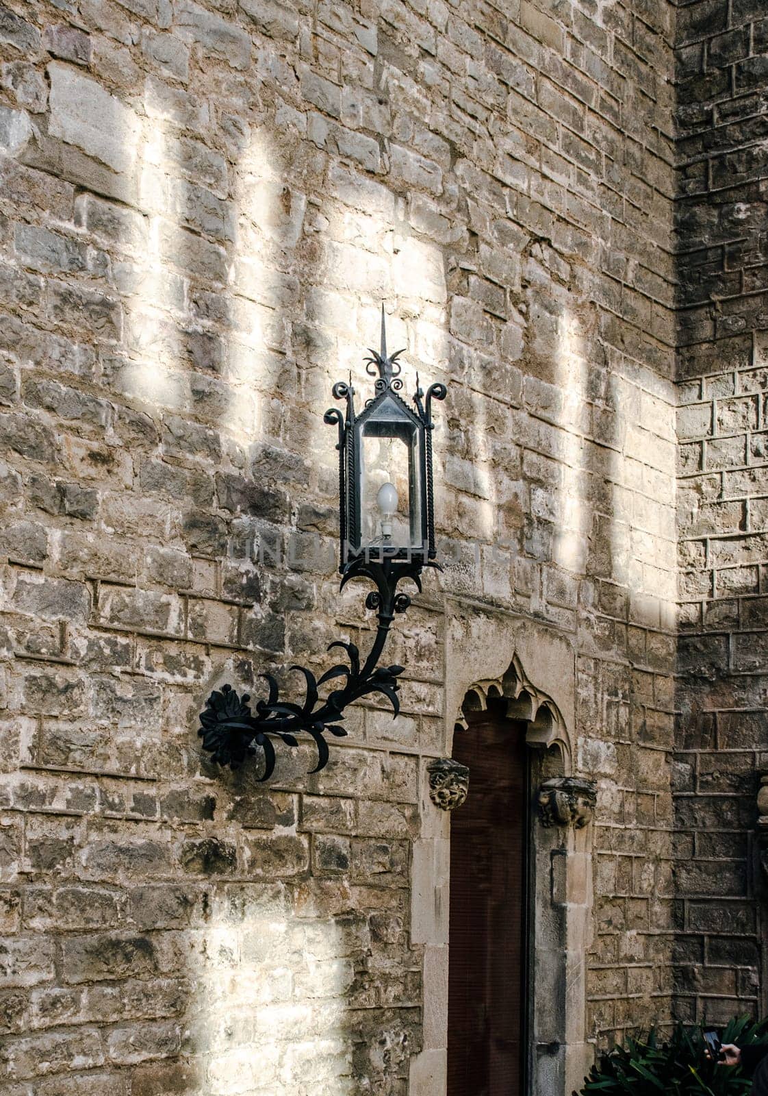 Gothic Quarter in Barcelona cityscape photo. Beautiful urban scenery photography with old brick wall and lantern. Street scene. High quality picture for wallpaper, article