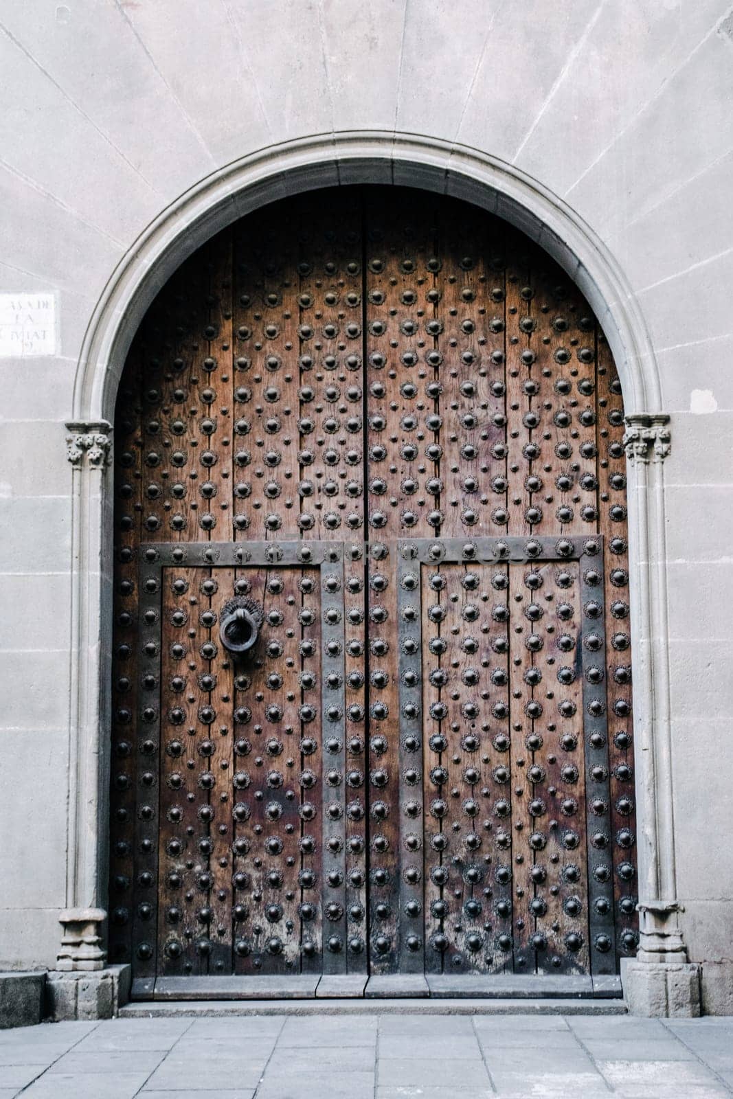 A medieval closed door with iron fittings in a stone wall. Typical architecture of Europe. by _Nataly_Nati_