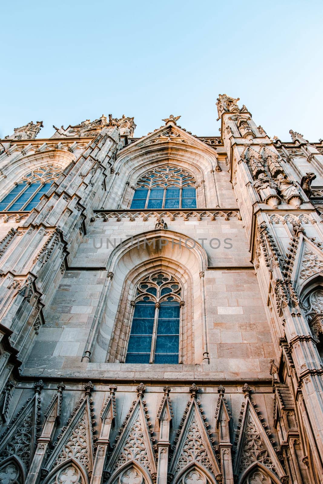 Cityscape photo of the Basilica of Saints Justus and Pastor, Barcelona. Beautiful urban scenery photography with ornamental wall. Street scene in Catalonia, Spain. High quality picture for wallpaper, article