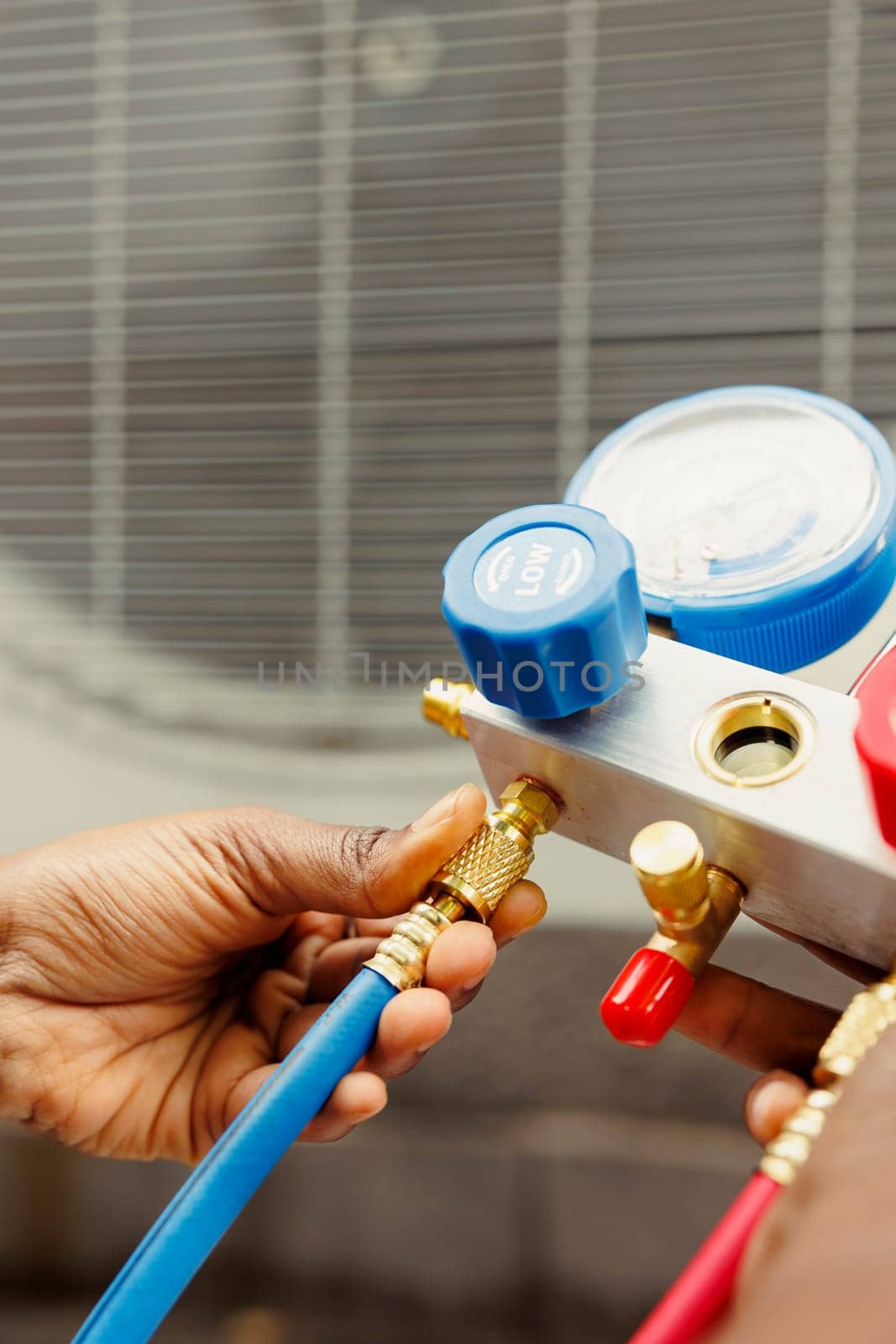 Close up of worker checking freon tank by DCStudio