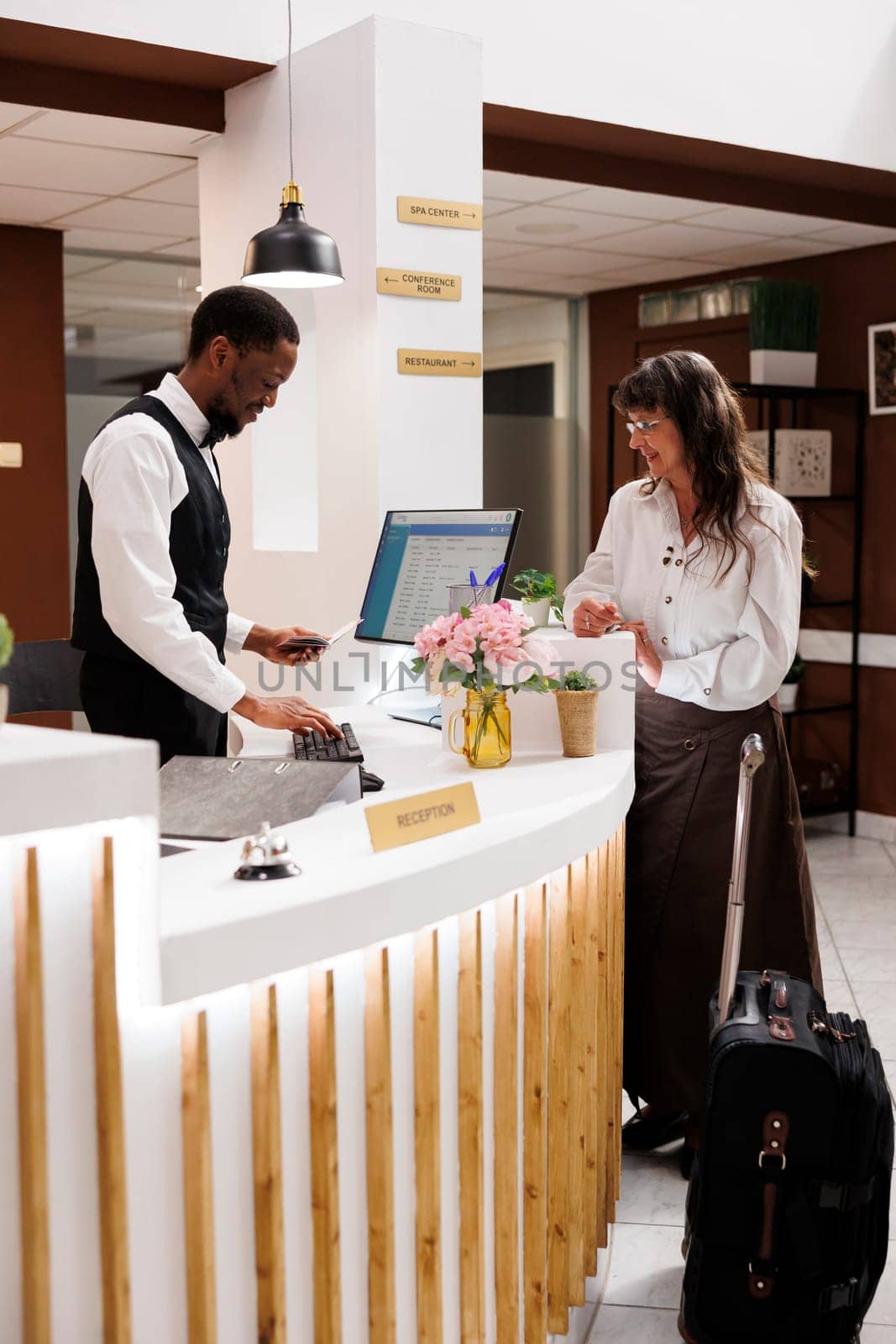 Hotel check-in with concierge assistance by DCStudio