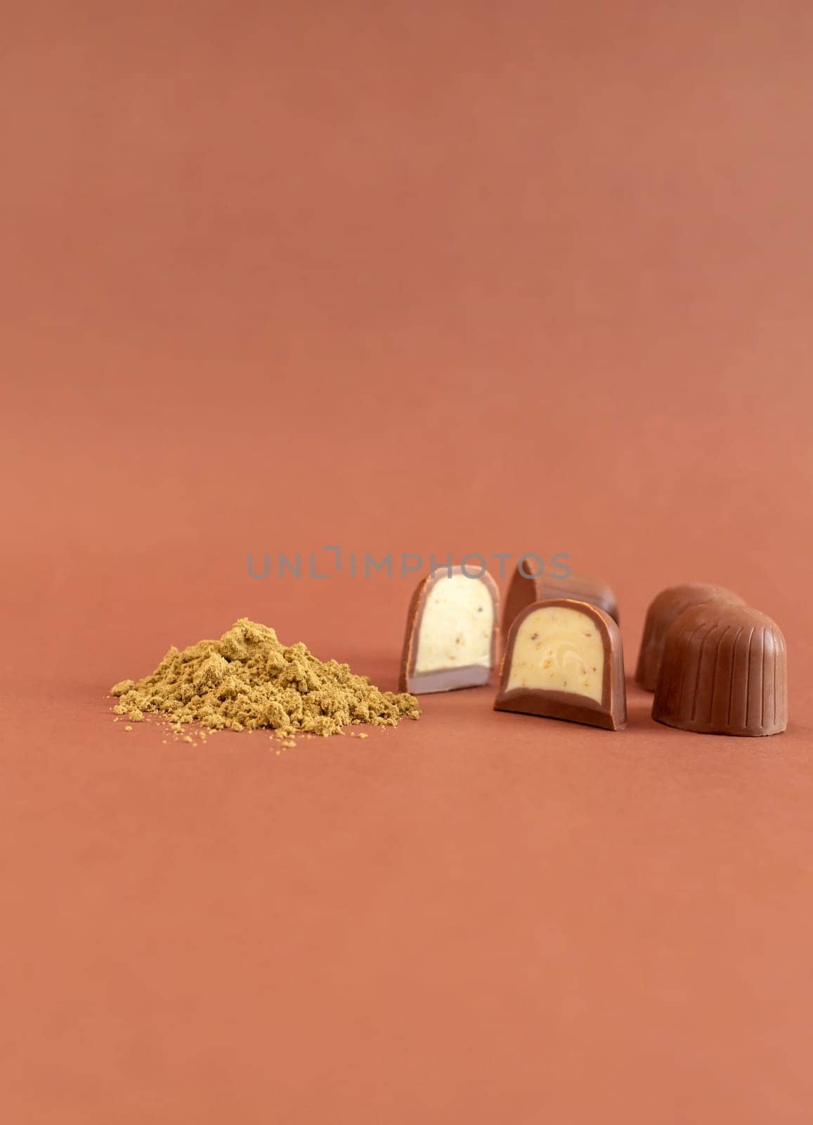 Mockup Brown Cannabis Chocolate Sweets And Green Hemp Protein Powder On Brown Background. Vertical Plane. Copy Space For Text. Healthy Snack. by netatsi