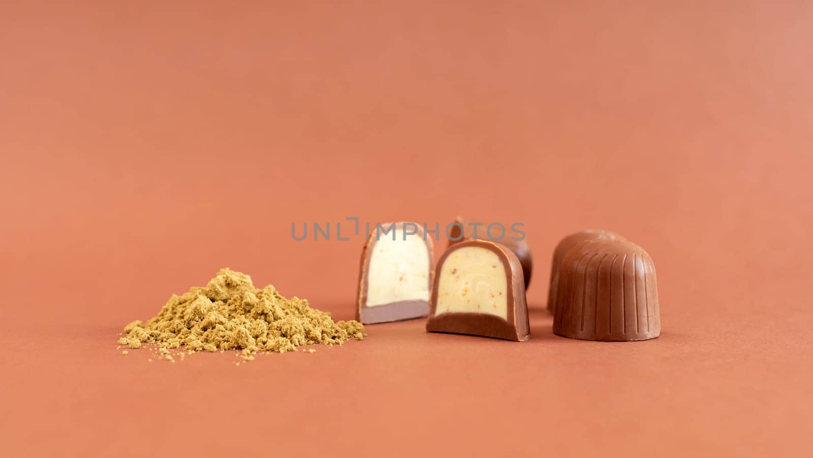 Mockup Brown Cannabis Chocolate Sweets And Green Hemp Protein Powder On Brown Background. Horizontal Plane. Copy Space For Text. Template Healthy Snack. by netatsi