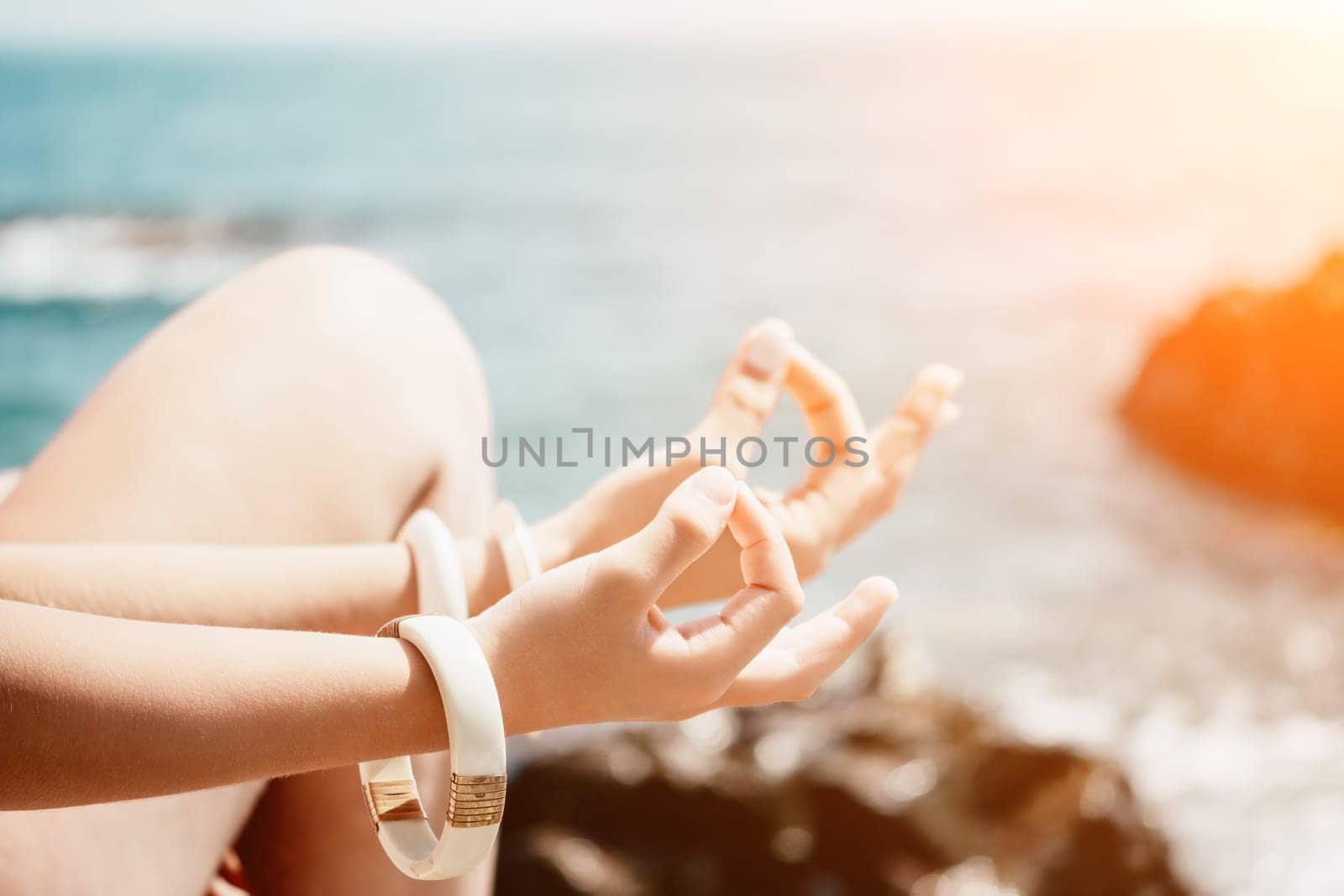 Close up Hand Gesture of Woman Doing an Outdoor Lotus Yoga Position. Close up. Blurred background