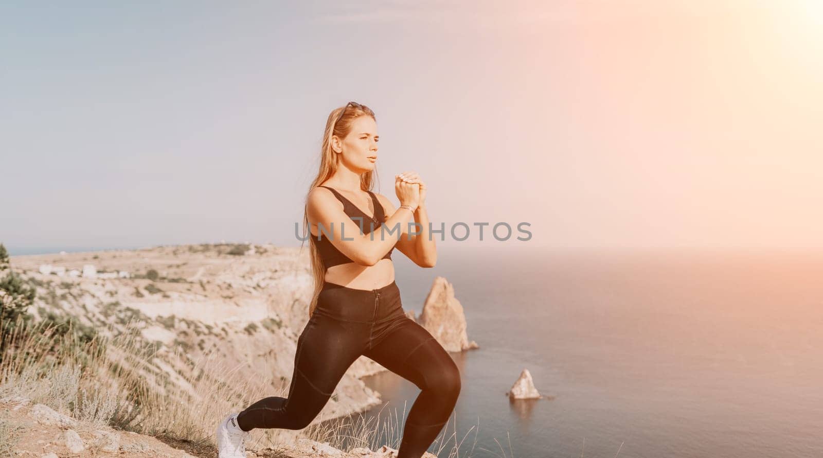 Fitness woman sea. Outdoor workout with fitness rubber bands in park over beach. Female fitness pilates yoga routine concept. Healthy lifestyle. Happy fit woman exercising with rubber band in park