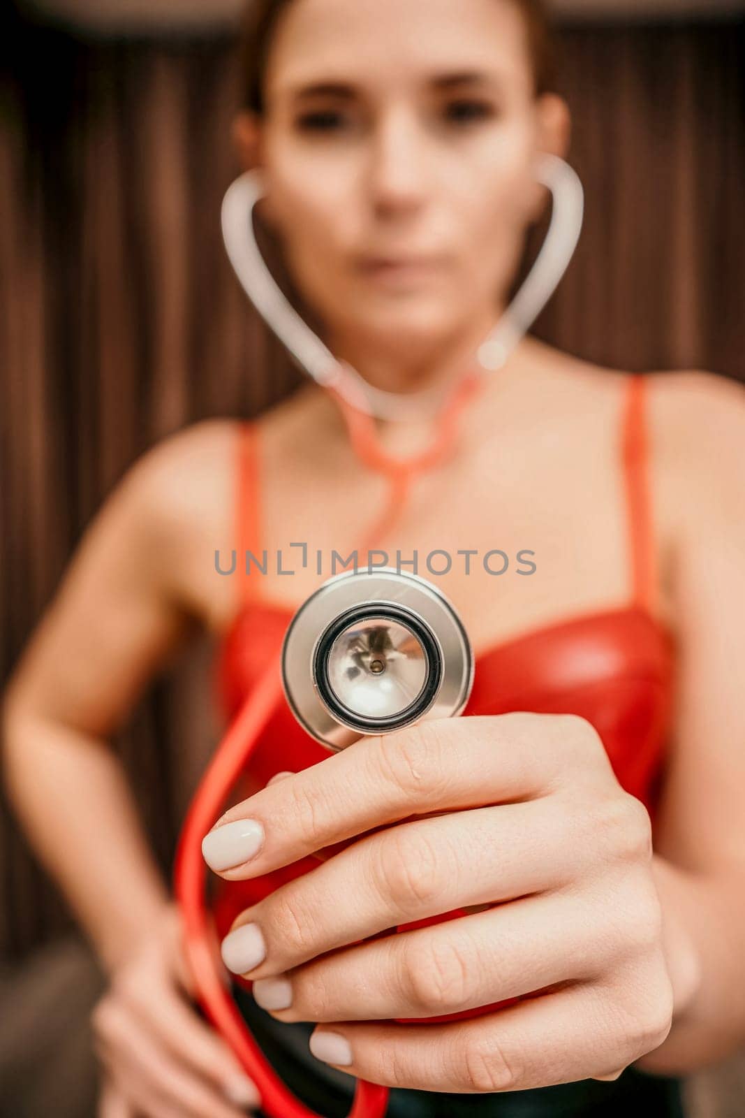 Selective focus. Young woman in red corset and black leather pan by panophotograph