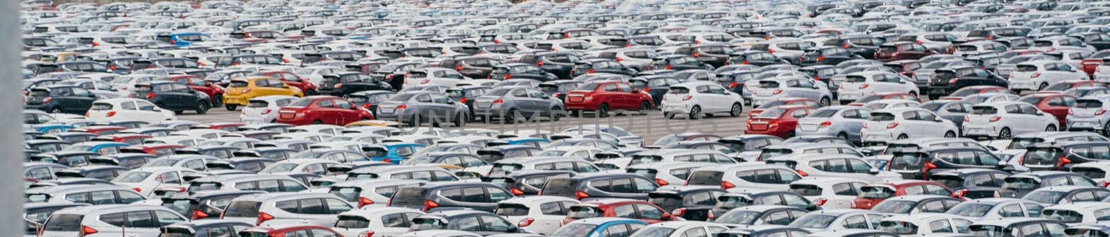 Lamchabang, Thailand - July 02, 2023 Amidst a car factory's distribution center, new sedans fill rows under the suna view from above showcases the crowded parking, a hub of global marketing.