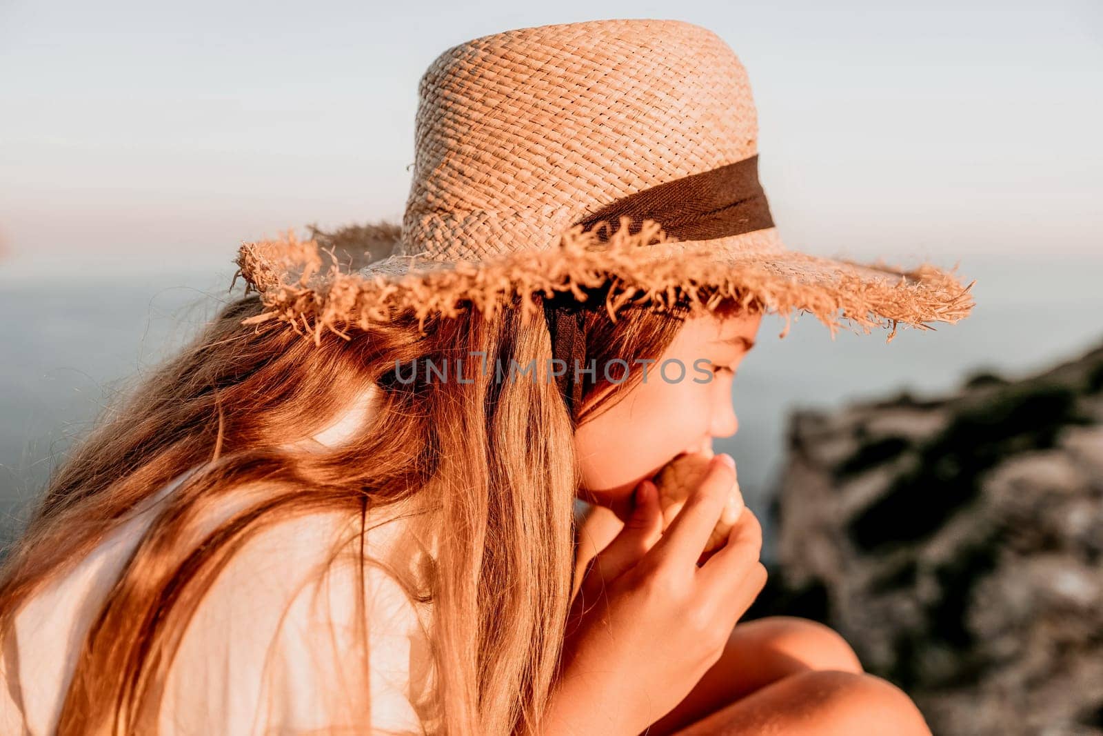 Portrait of young beautiful girl eating corn. Snacking on the sea