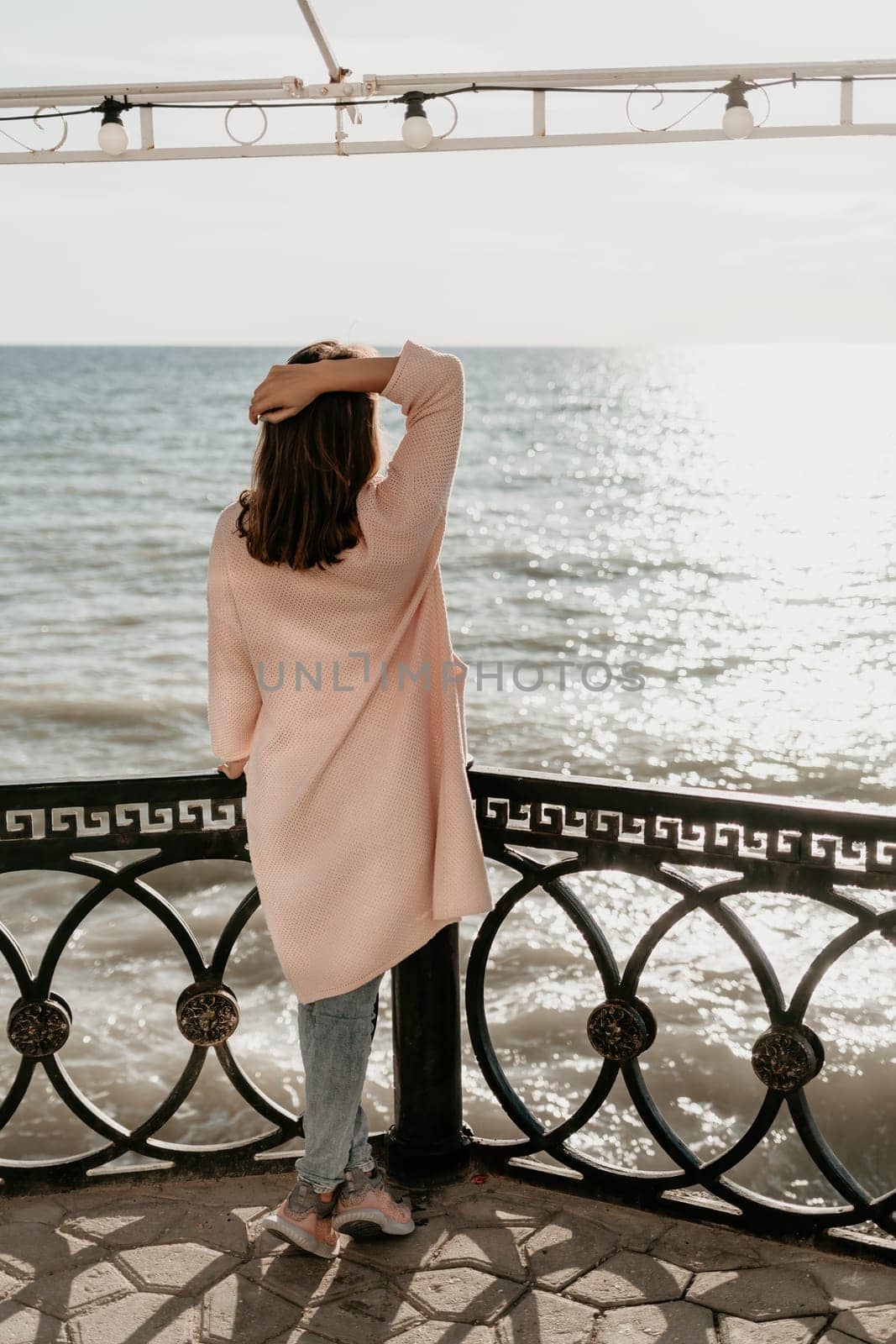 Woman summer travel sea. Happy tourist enjoy taking picture outdoors for memories. Carefree woman traveler posing on beach at sea on sunset, sharing travel adventure journey. Holiday vacation concept. by panophotograph