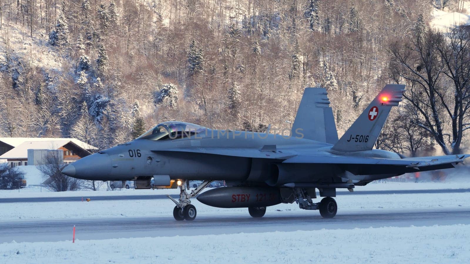Meiringen Switzerland January 19 2023: Fighter jet taxiing in white winter snow scenario. Copy Space. Boeing F-18 Hornet of Swiss Air Force air defense for World Economic Forum WEF in Davos.