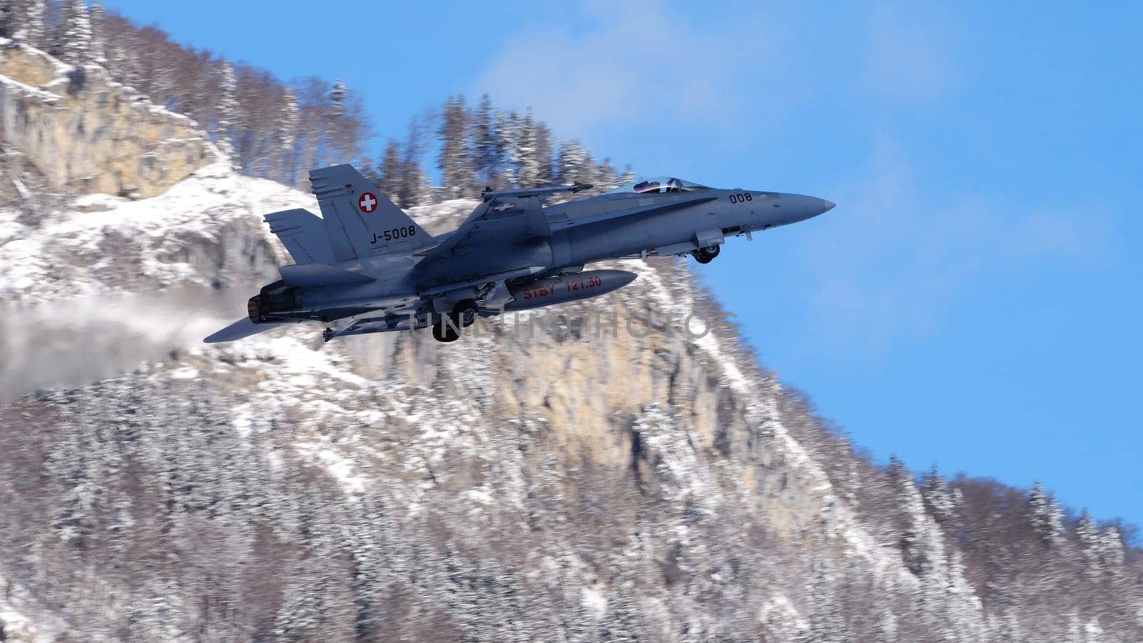 Meiringen Switzerland January 19 2023: Modern supersonic air defense jet lifts off against a spectacular snowy mountain panorama for security mission for World Economic Forum WEF in Davos. Copy Space