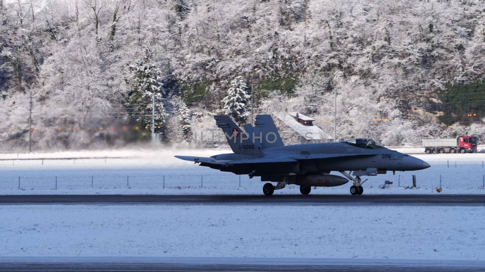 Switzerland January 19 2023: F-18 Hornet of Swiss Air Force taxiing on runway in enchanting snowy landscape of Meiringen airport ready for winter mission during the World Economic Forum WEF in Davos