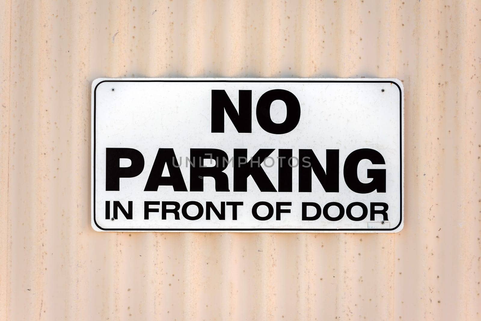 no parking in front of door sign black on white