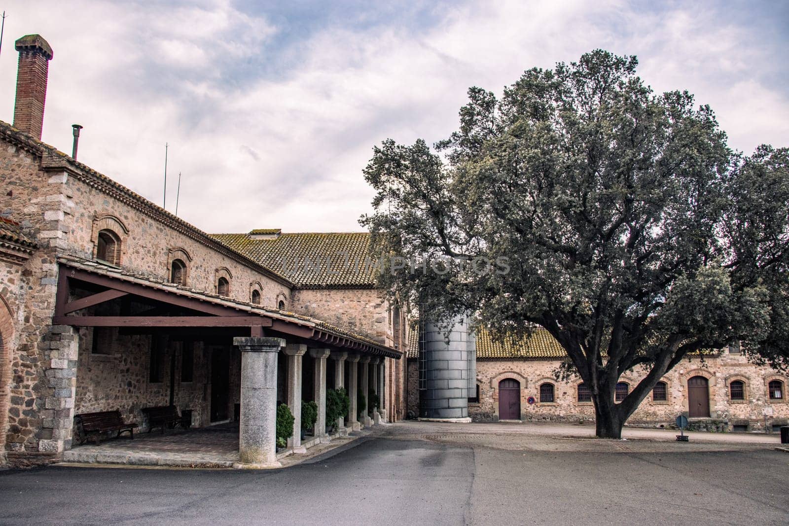 The exterior of an old winter farm yard concept photo. Backyard with old buildings in Catalonia countryside. Old brick wall texture background. High quality picture for wallpaper, article