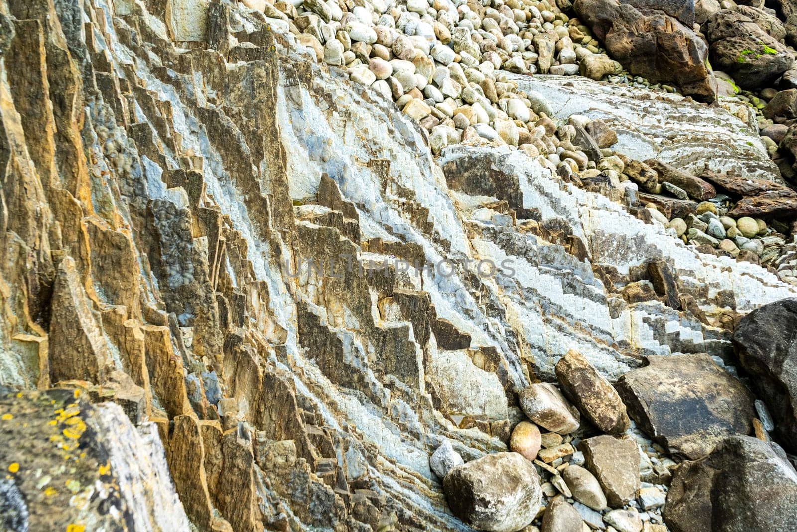 Rocky ocean shore. Pebbles and boulders on the seashore