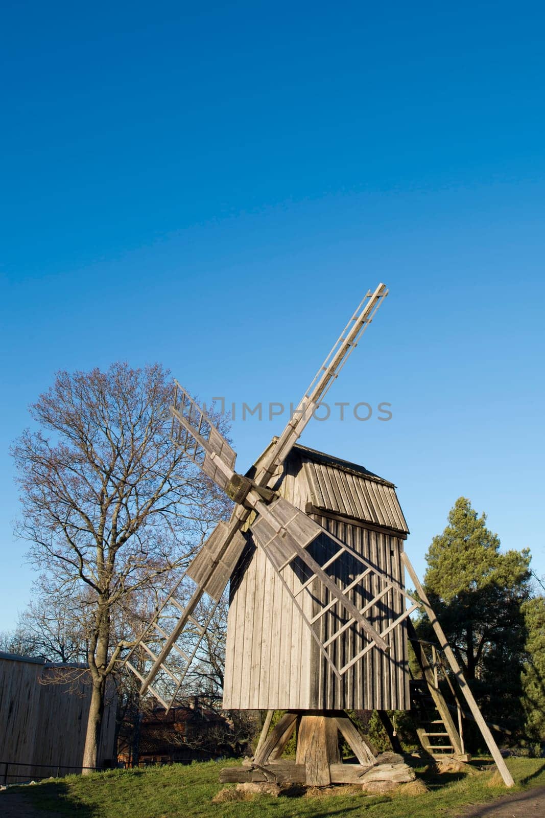 wooden windmill on the blue sky background