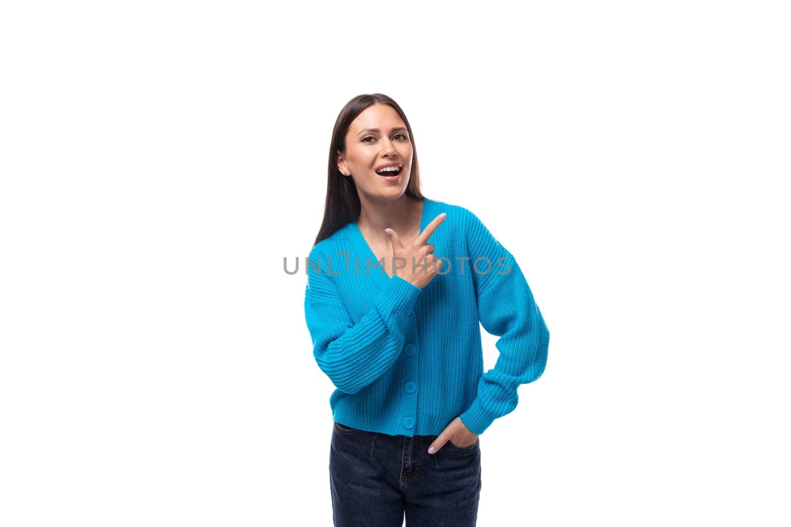young pretty european brunette woman dressed in a blue button-down sweater on a white background with copy space by TRMK