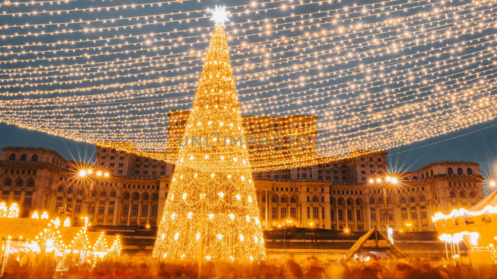 People in front of Christmas tree  by vladispas
