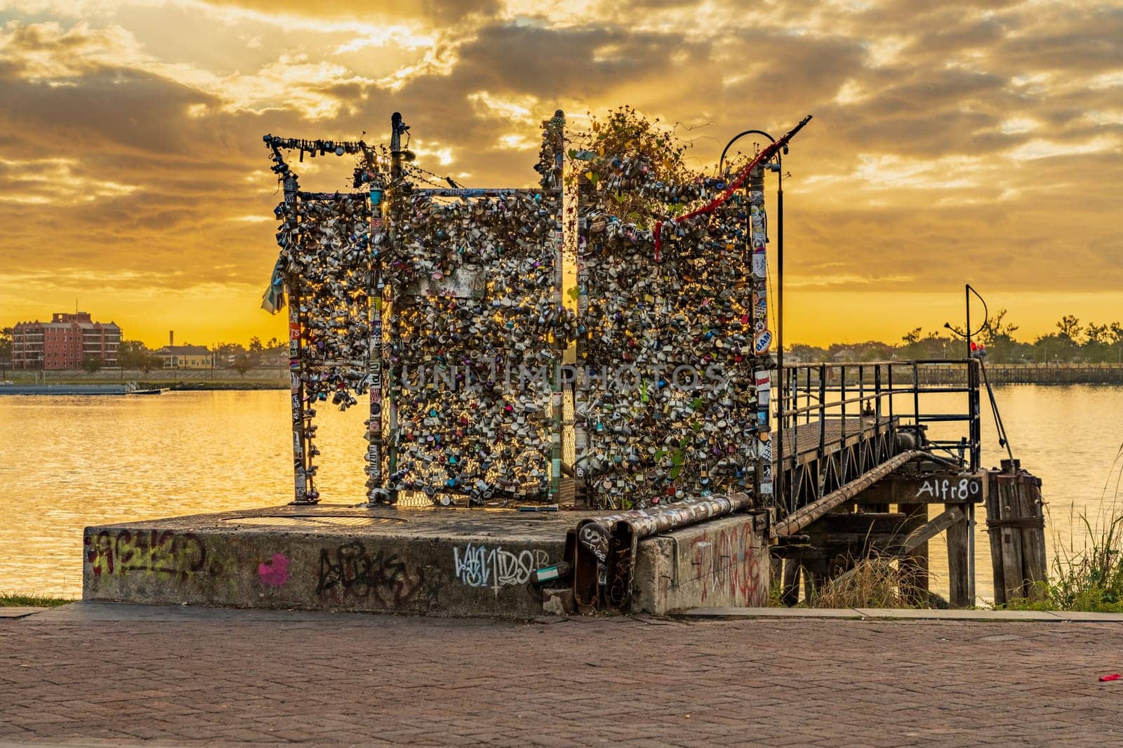 Fence covered with lovers padlocks in New Orleans at sunrise by steheap
