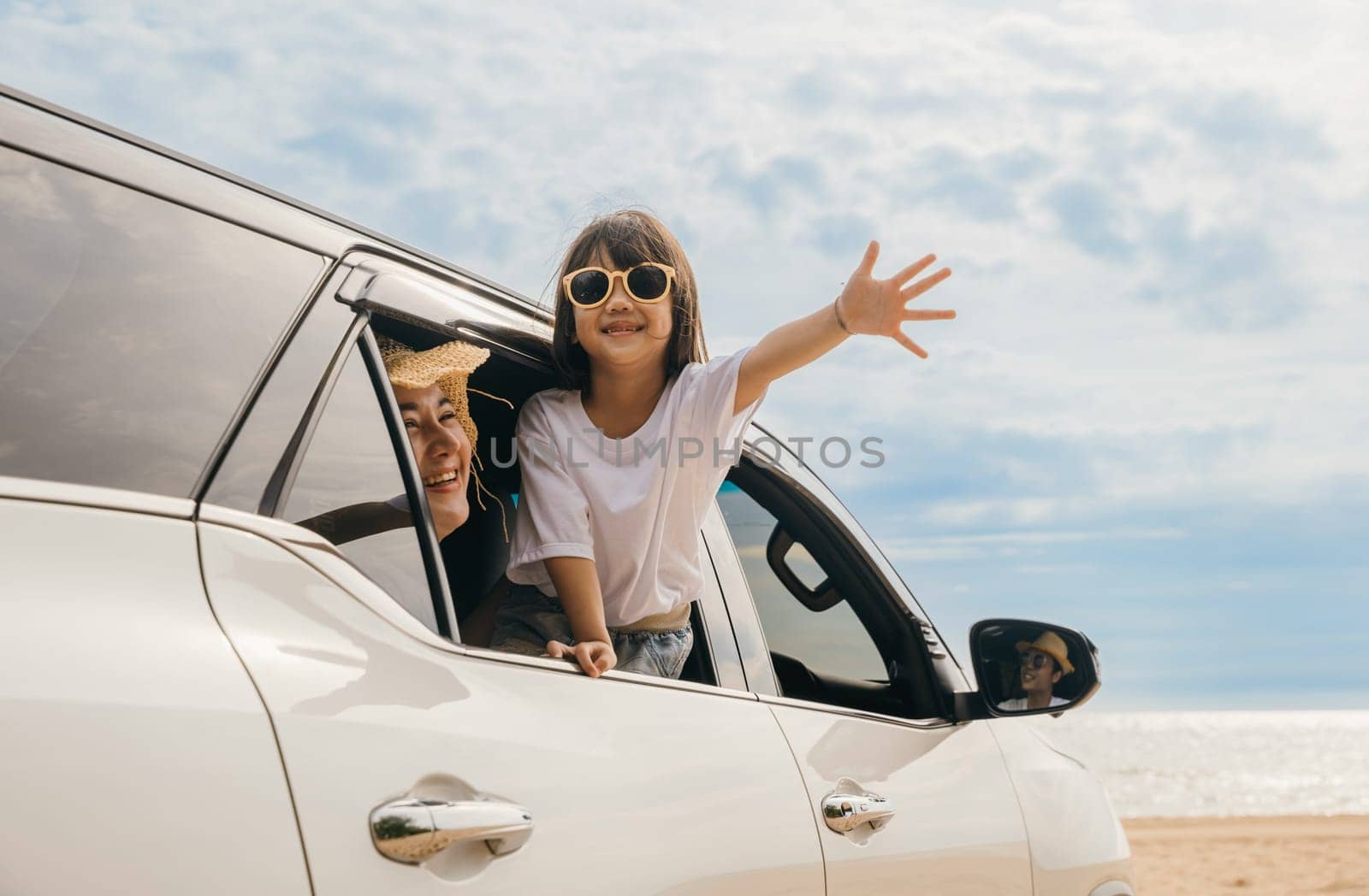 Happy family day. Asian Dad, mom and daughter little kid smiling sitting in compact car windows raise hand wave goodbye, Summer at beach, Car insurance, Family holiday vacation travel, road trip