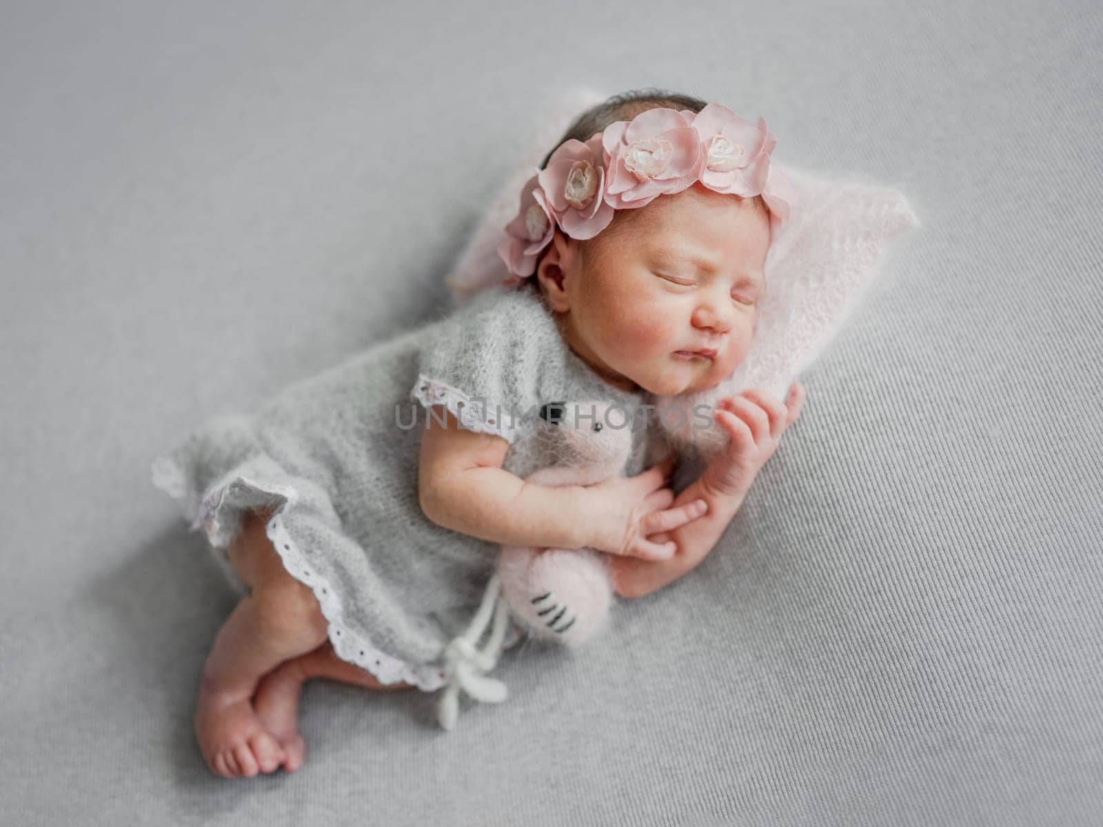 Newborn Girl Sleeps In Gray Dress With Flamingo Toy by tan4ikk1