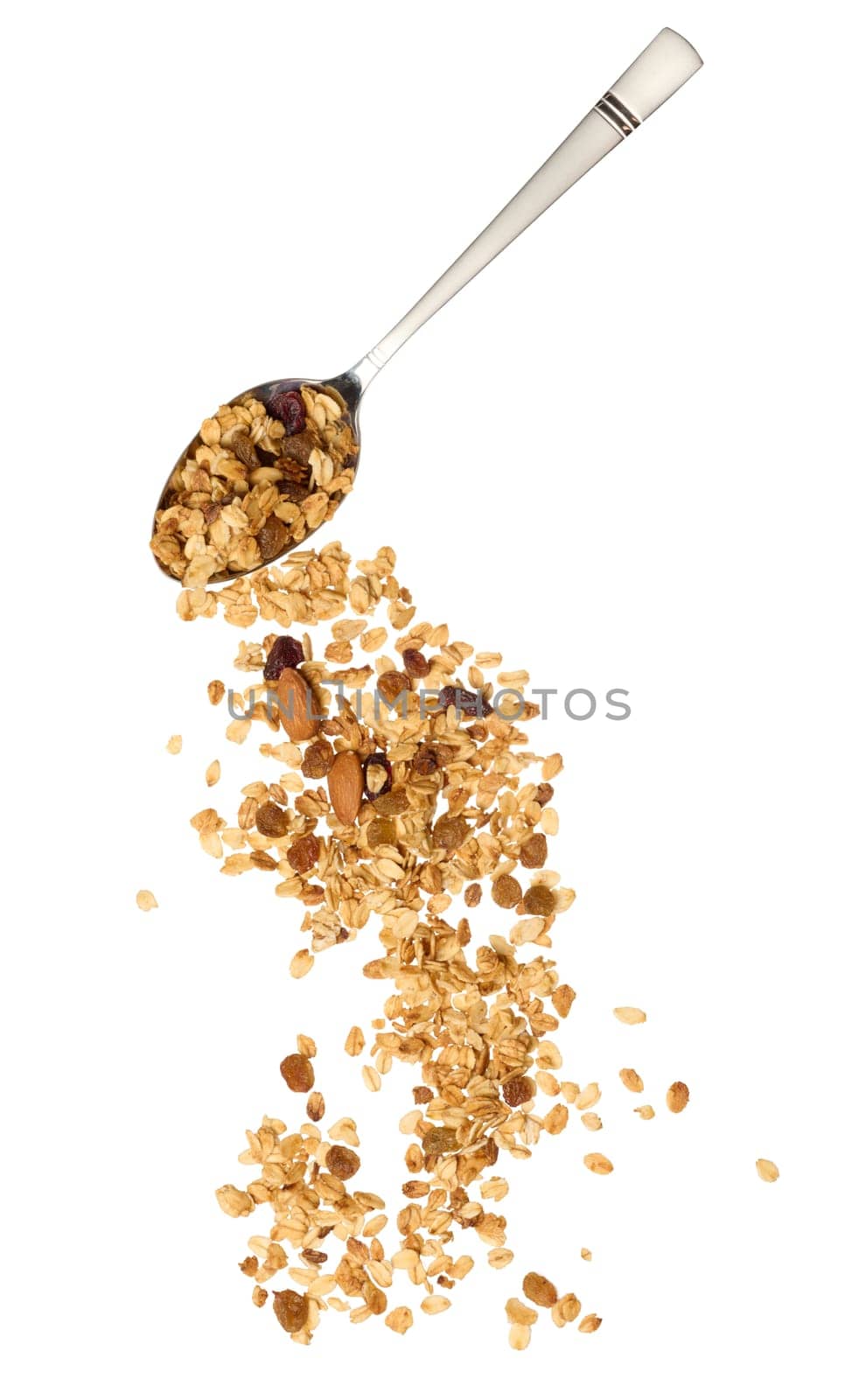 Oatmeal, raisins, cashews and almonds. Granola pours out of a metal spoon by ndanko