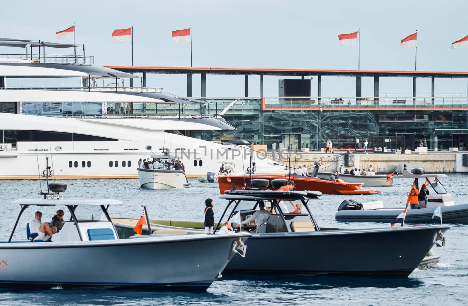 Monaco, Monte Carlo, 29 September 2022 - Water taxi by luxury motorboat on the famous yacht exhibition, a lot of most expensive luxury yachts, richest people, yacht brokers, boat traffic by vladimirdrozdin