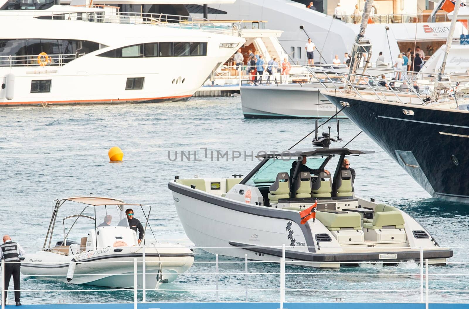 Monaco, Monte Carlo, 29 September 2022 - Water taxi by luxury motorboat on the famous yacht exhibition, a lot of most expensive luxury yachts, richest people, yacht brokers, boat traffic by vladimirdrozdin