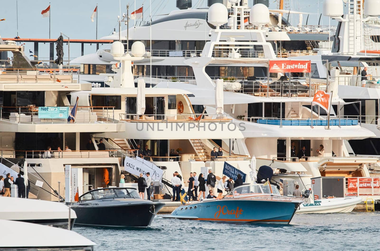 Monaco, Monte Carlo, 29 September 2022 - Water taxi by luxury motorboat on the famous yacht exhibition, a lot of most expensive luxury yachts, richest people, yacht brokers, boat traffic by vladimirdrozdin