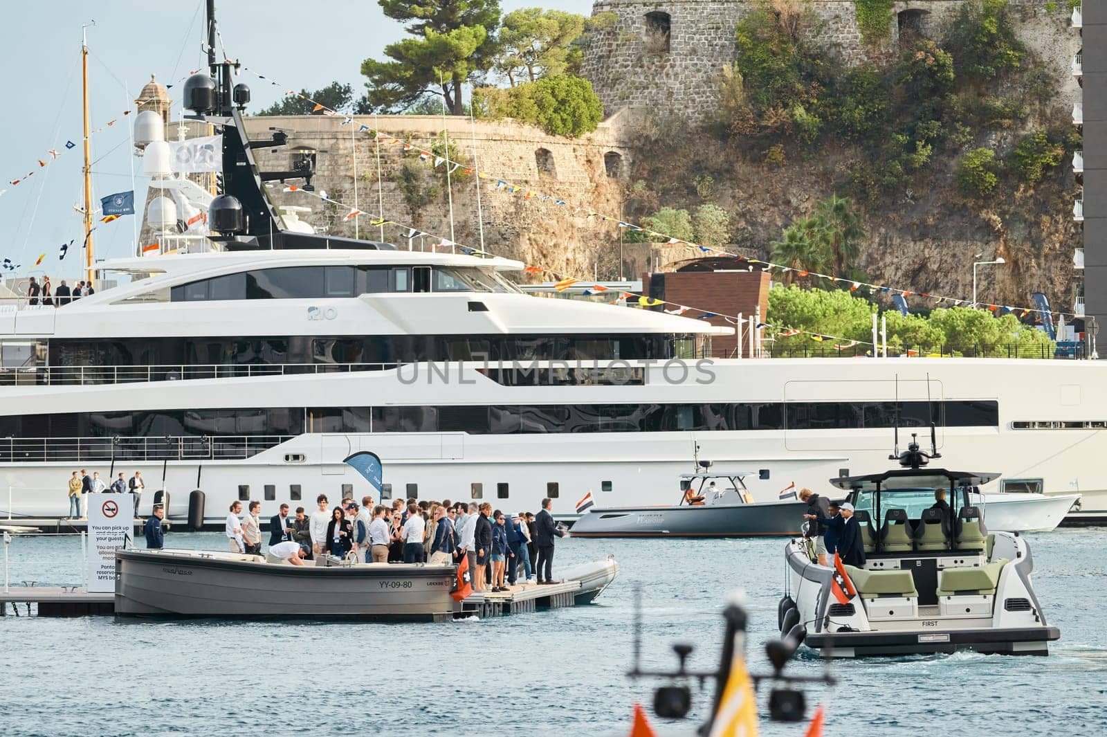 Monaco, Monte Carlo, 29 September 2022 - Water taxi by luxury motorboat on the famous yacht exhibition, a lot of most expensive luxury yachts, richest people, yacht brokers, boat traffic. High quality photo