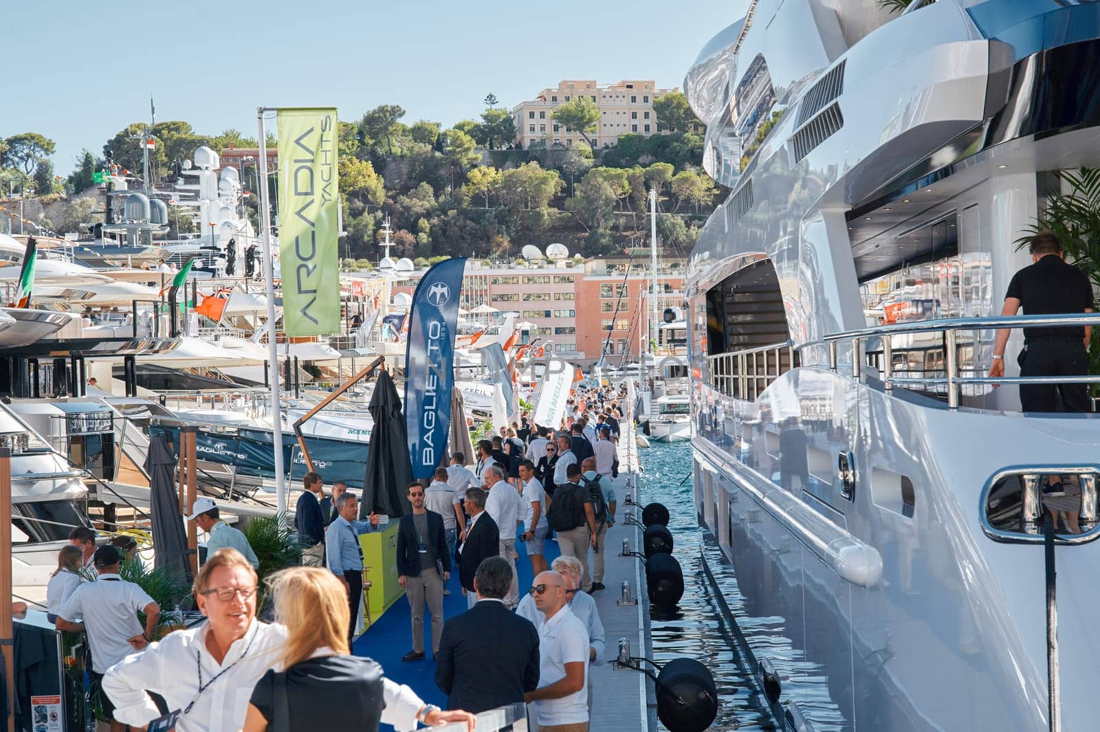 Monaco, Monte Carlo, 28 September 2022 - a lot of people, clients and yacht brokers look at the mega yachts presented, discuss the novelties of the boating industry at the famous motorboat exhibition. High quality photo