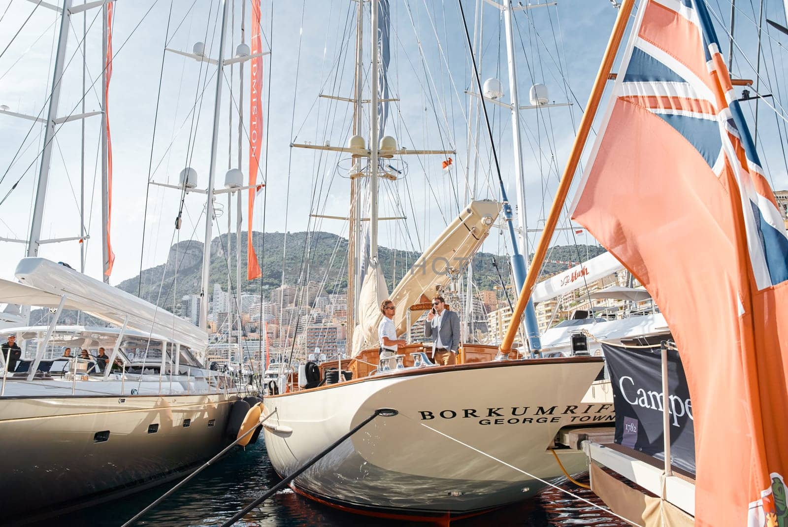 Monaco, Monte Carlo, 29 September 2022 - Invited wealthy clients inspect mega yachts at the largest fair exhibition in the world yacht show MYS, port Hercules, yacht brokers, sunny weather by vladimirdrozdin