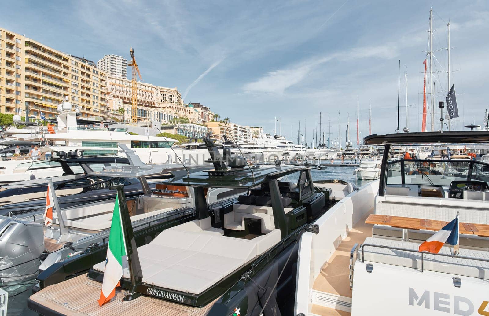 Monaco, Monte Carlo, 29 September 2022 - Close-up view of a relaxation area on the open teak deck of an expensive motorboat on famous boating exhibition at sunny day, yacht show, wealth life. High quality photo
