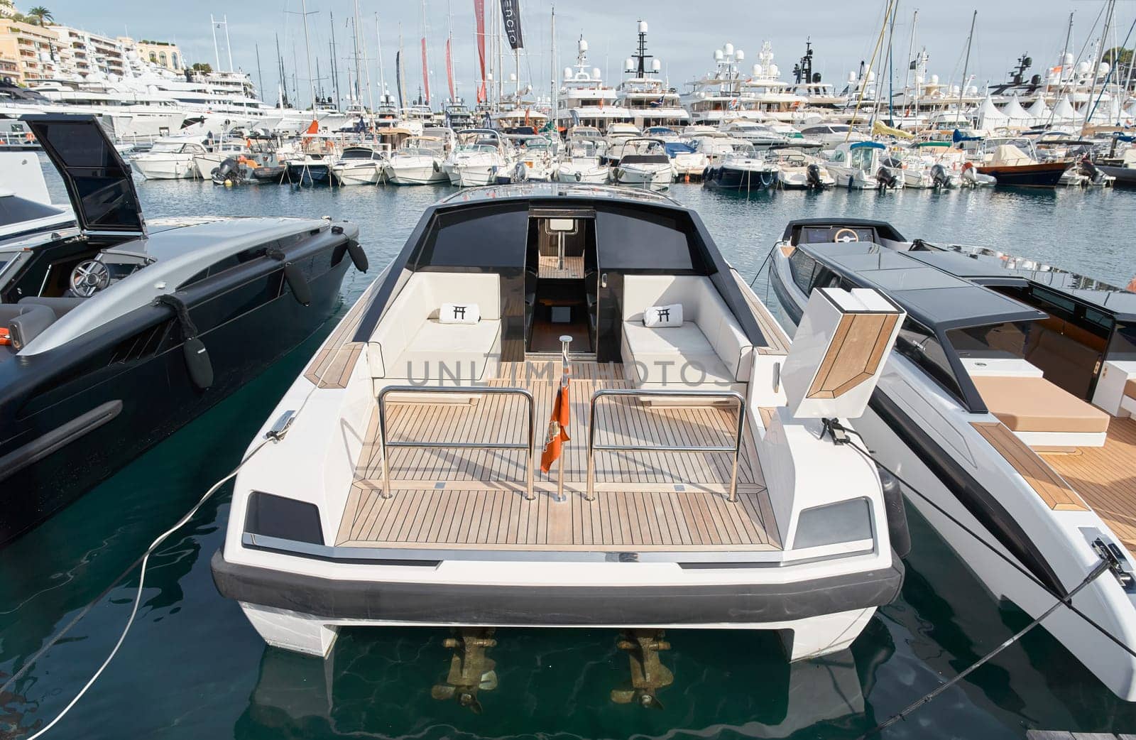 Monaco, Monte Carlo, 29 September 2022 - Close-up view of a relaxation area on the open teak deck of an expensive motorboat on famous boating exhibition at sunny day, yacht show, wealth life. High quality photo