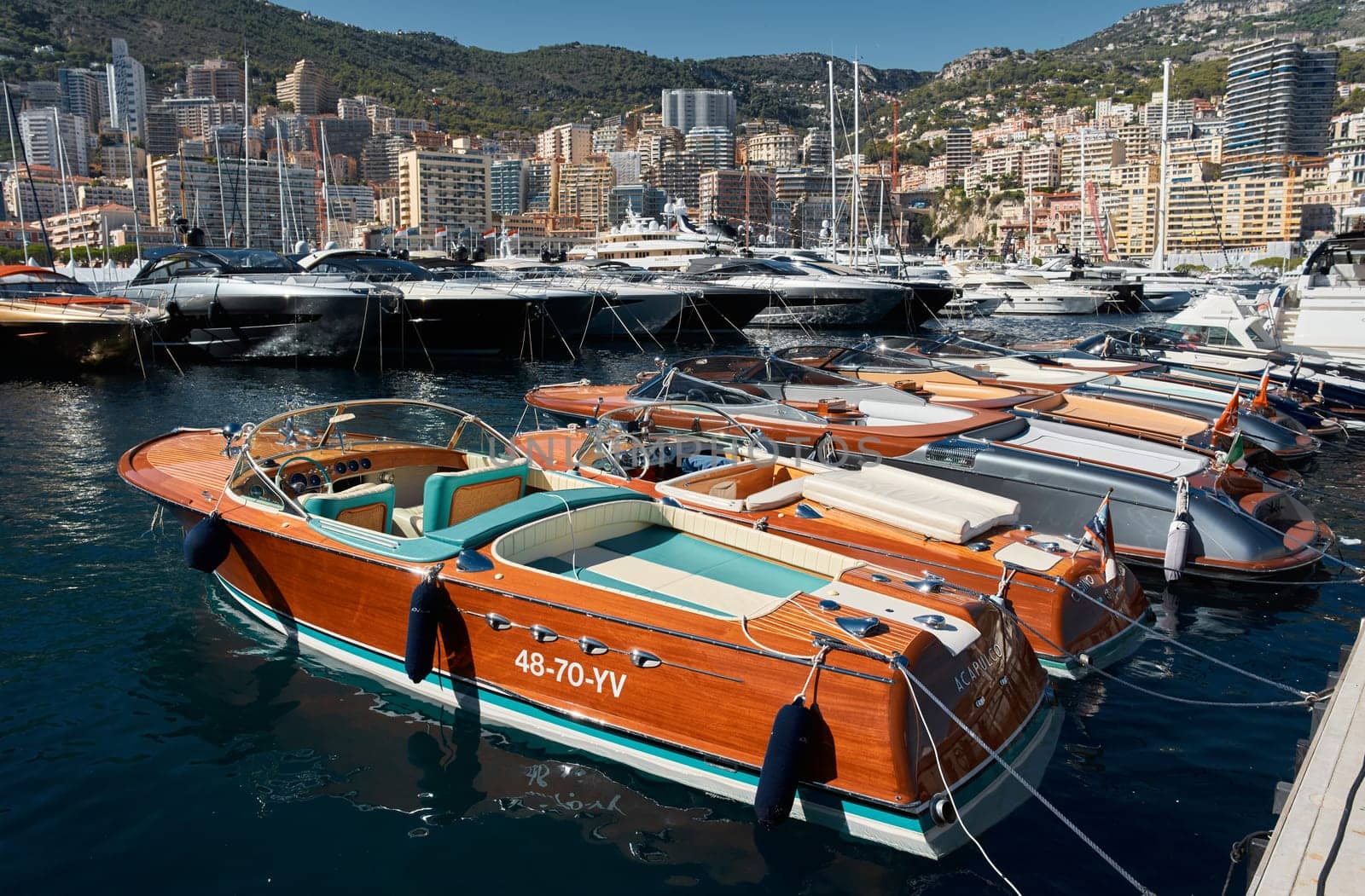 Monaco, Monte Carlo, 28 September 2022 - Riva boats in a row and a lot of luxury mega yachts at the famous motorboat exhibition in the principality, yacht brokers and clients by vladimirdrozdin