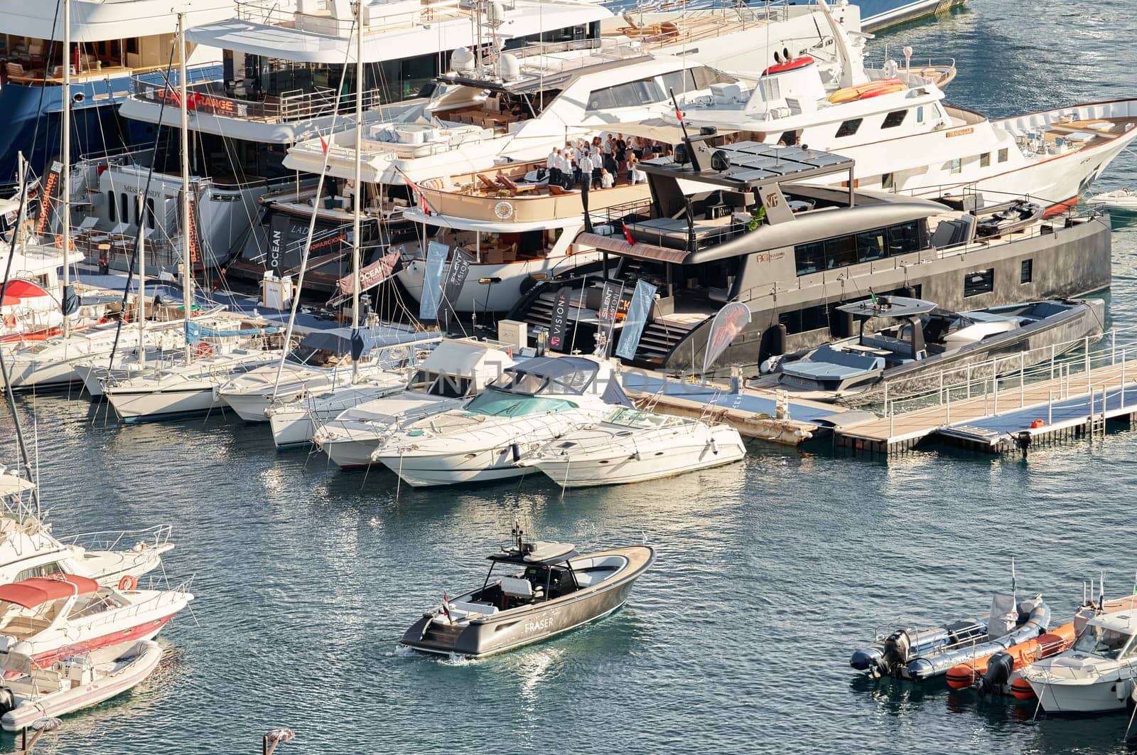 Monaco, Monte Carlo, 29 September 2022 - Water taxi by luxury motorboat on the famous yacht exhibition, a lot of most expensive luxury yachts, richest people, yacht brokers, boat traffic by vladimirdrozdin