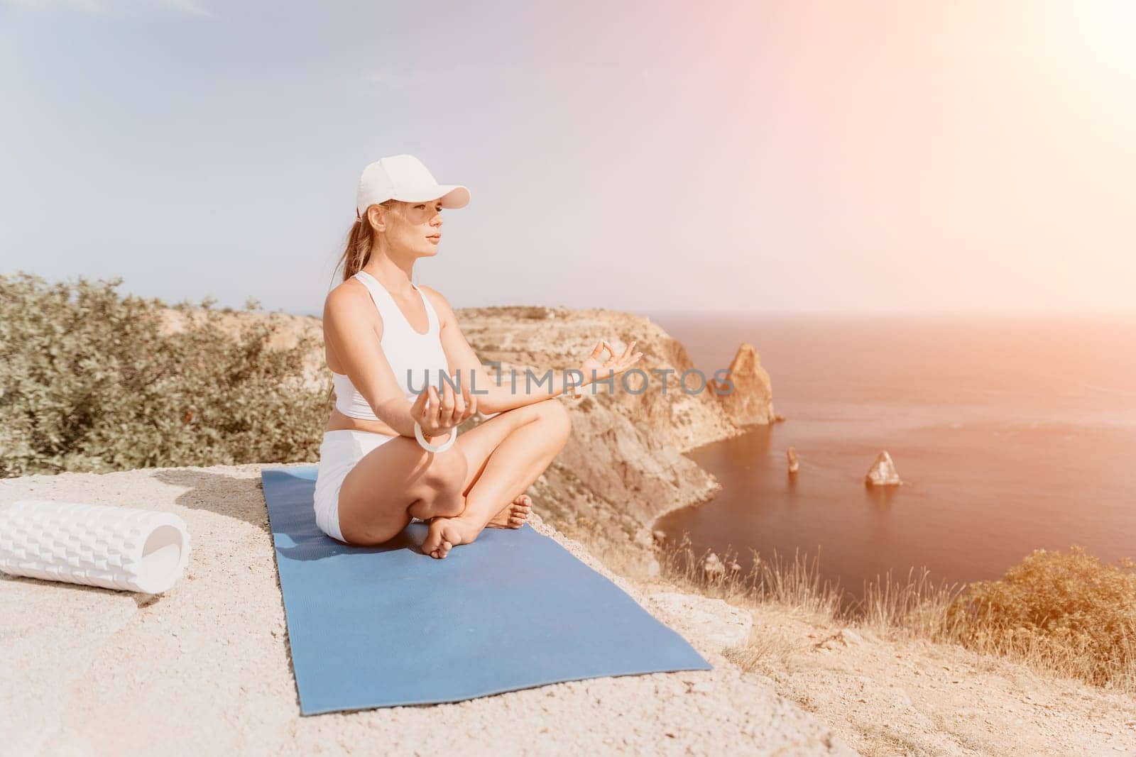 Fitness woman sea. Outdoor workout with fitness rubber bands in park over beach. Female fitness pilates yoga routine concept. Healthy lifestyle. Happy fit woman exercising with rubber band in park