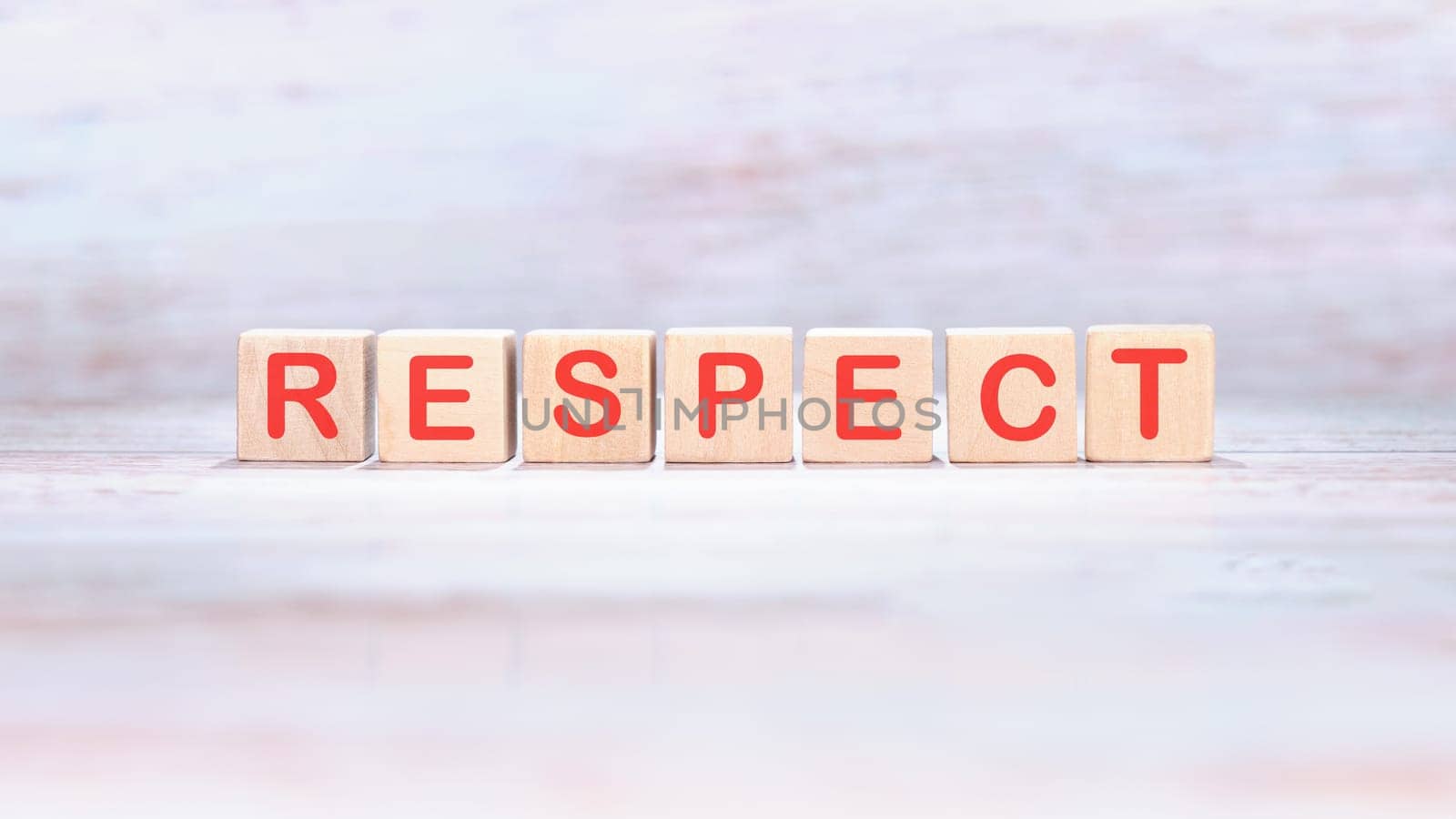 respect word made of wooden cubes on a light background by Ihar