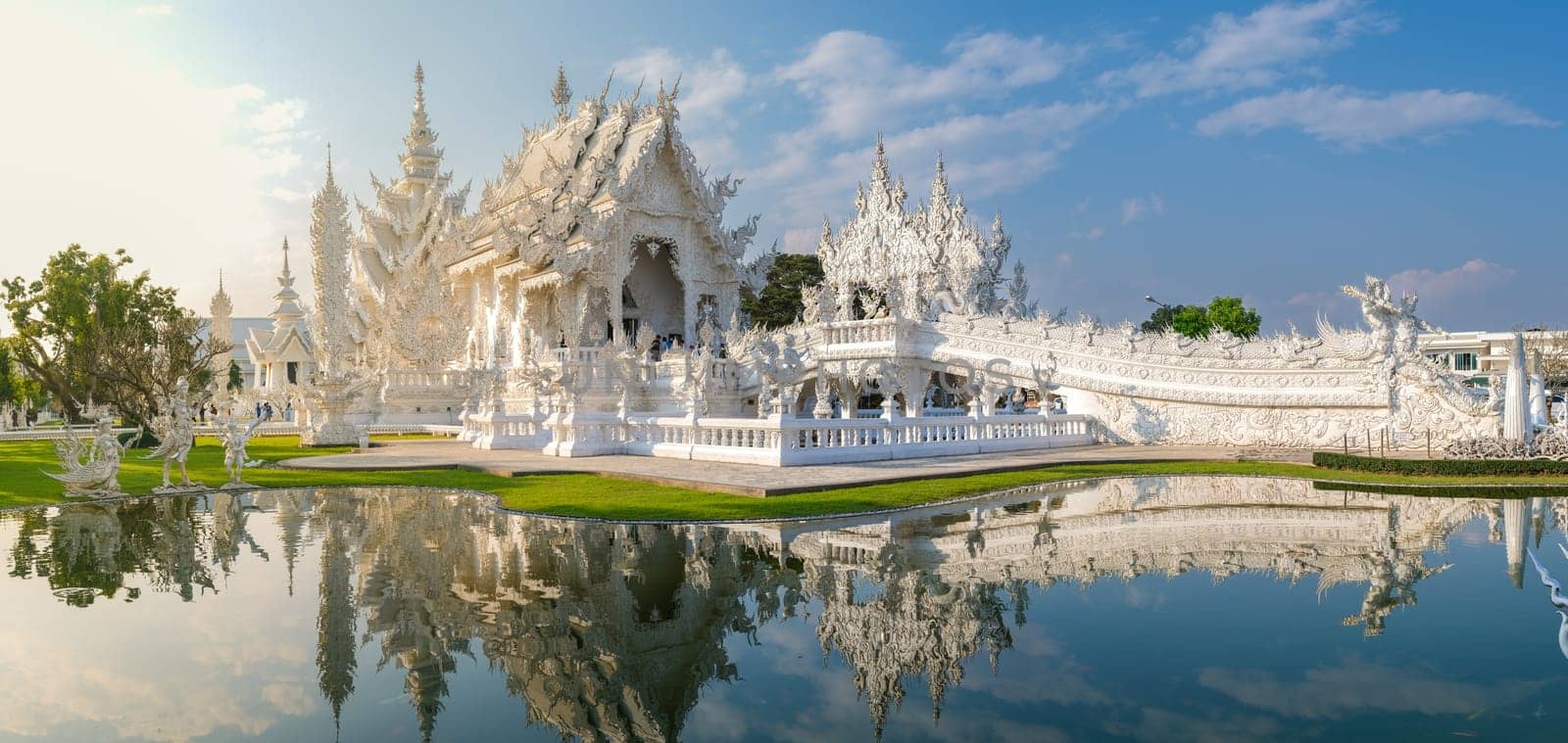White Temple Chiang Rai Thailand, Wat Rong Khun Northern Thailand. beautiful reflection in the pond with soft sunlight