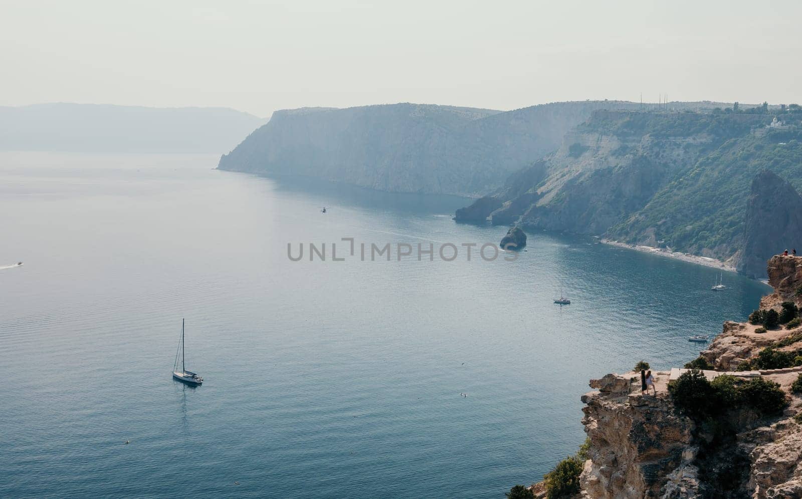 Aerial view from above on calm azure sea and volcanic rocky shores. Small waves on water surface in motion blur. Nature summer ocean sea beach background. Nobody. Holiday, vacation and travel concept by panophotograph