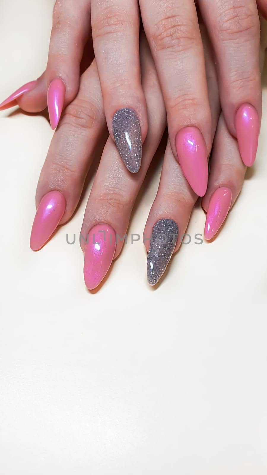 Acrylic nail extension, manicure, nail correction, hands in the foreground. Bright design. copy space